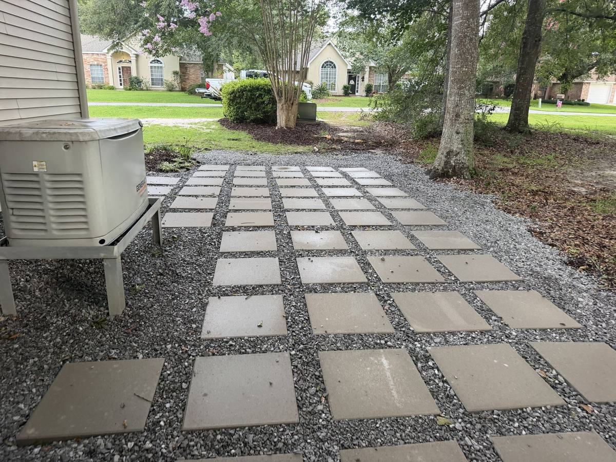 Paver walkway with gravel joints running along the side yard of a Northshore home