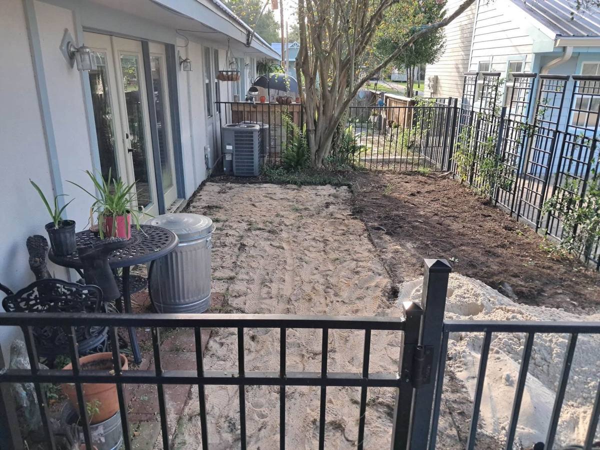 Fenced side yard regraded and backfilled after a drainage installation